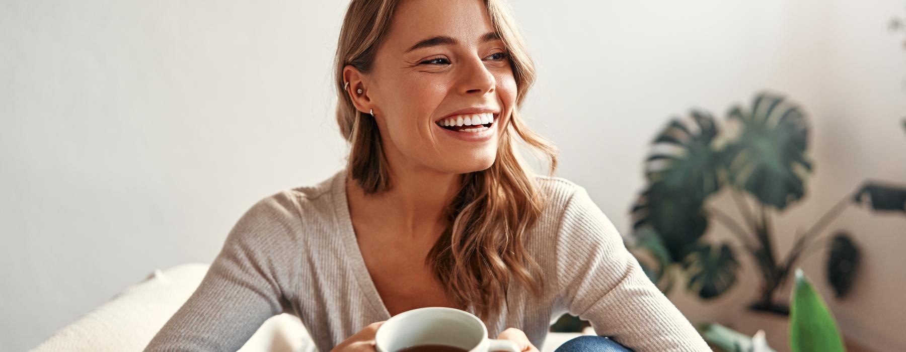 a woman holding a cup