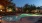 a swimming pool with a house in the background