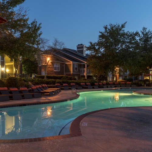 a swimming pool with a house in the background